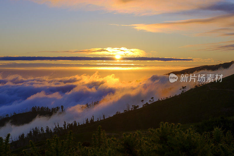 Clouds over the mountains near Rabaçal on Madeira island during sunset